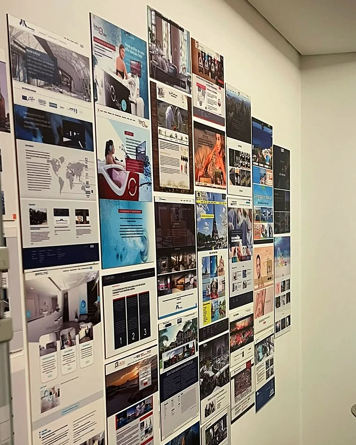 A wall at the Besiders office covered with printed pages of websites we have designed